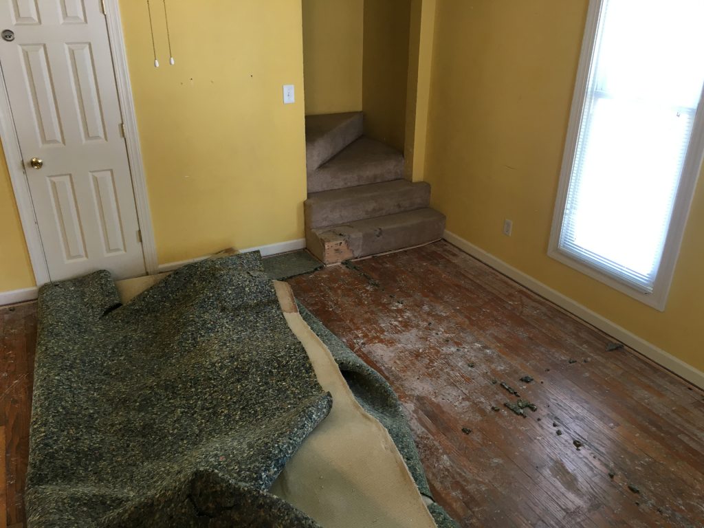 Carpet pulled up and walls/carpet damaged.